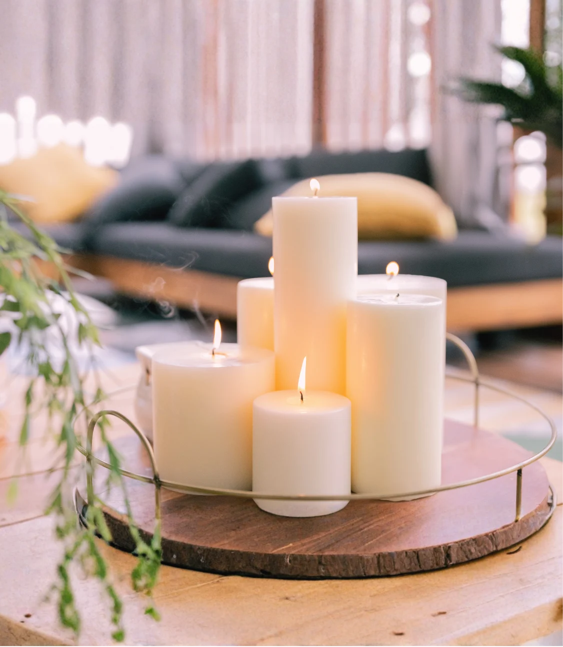 Lit candles arranged on a round wooden tray